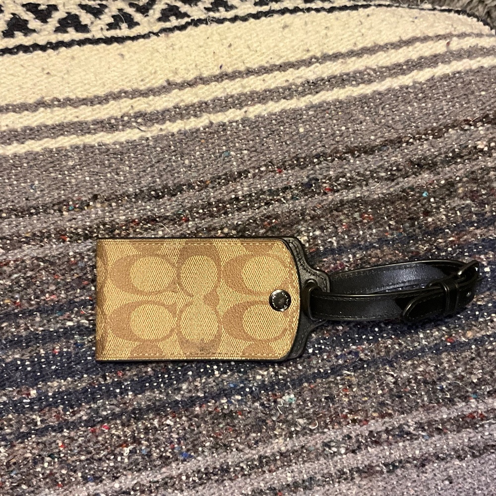 Coach luggage tag in signature canvas.  Tan and brown in color.